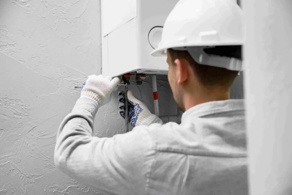 worker repairing water heater